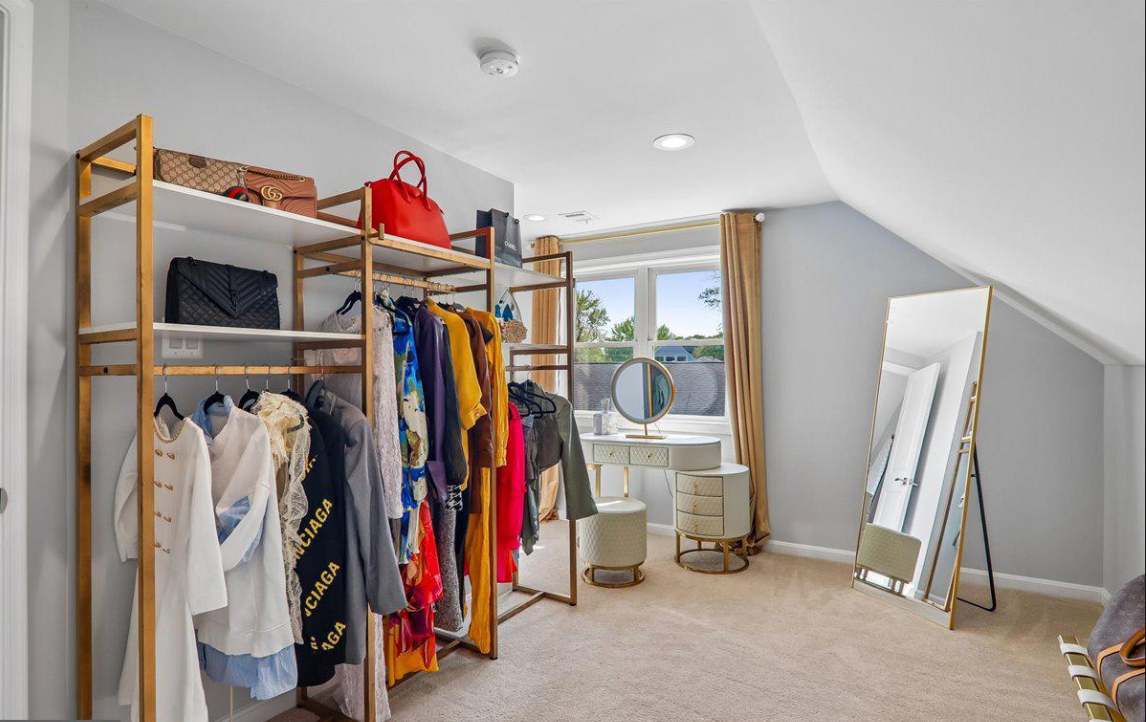 Walk-in closet with vanity and full-length mirror